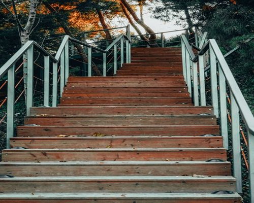 Sturdy clean modern stairs in a sunlit public park path encouraging light daily physical climbing habits